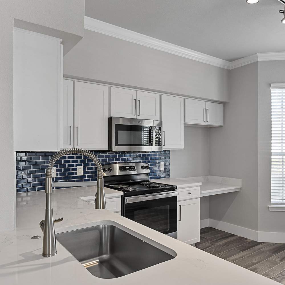 Kitchen with white cabinetry at Lyndon in Houston,Texas