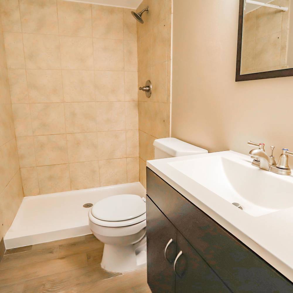 Apartment bathroom with warm accent at Wellshire Apartments in Denver,Colorado