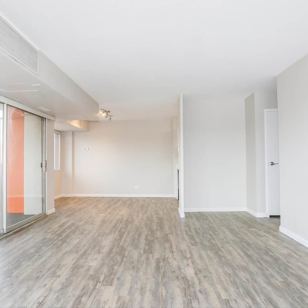 Unfurnished living room with hardwood flooring at Wellshire Apartments in Denver,Colorado