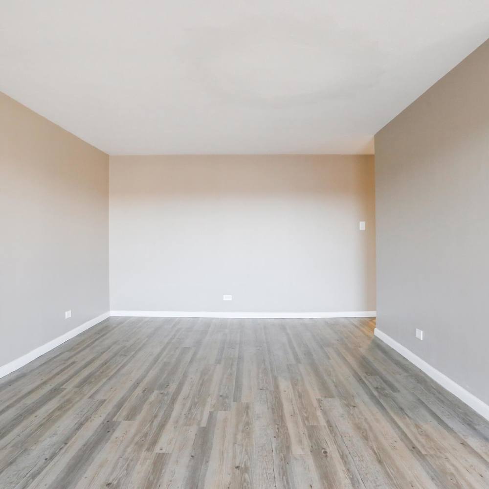 Apartment bedroom with wood-style flooring at Wellshire Apartments in Denver,Colorado