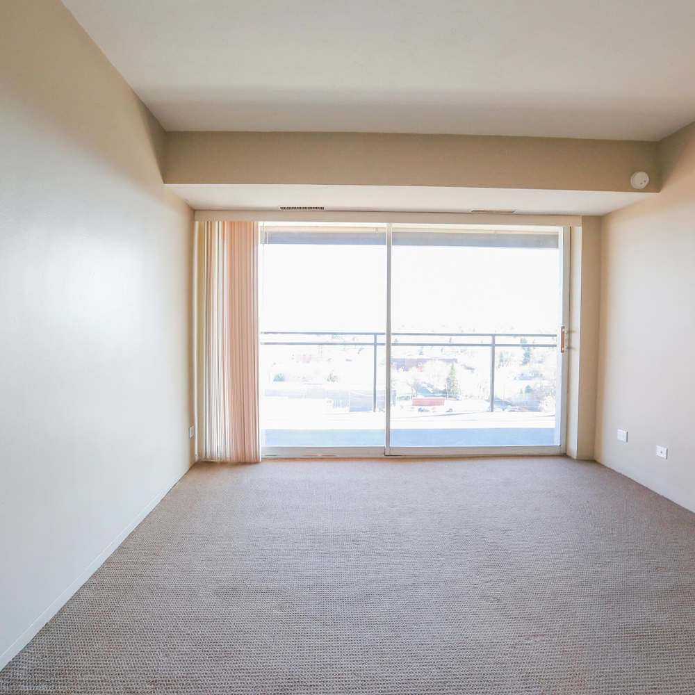 Living room with access to private balcony at Wellshire Apartments in Denver,Colorado