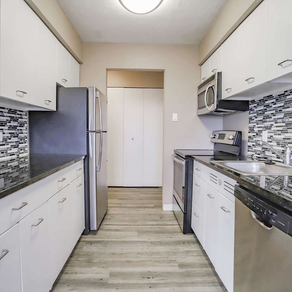 Kitchen with white cabinets at Wellshire Apartments in Denver,Colorado