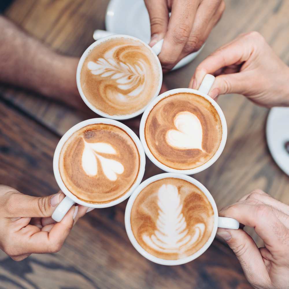 Friends drinking lattes near Proximity Carolina Beach in Carolina Beach, North Carolina