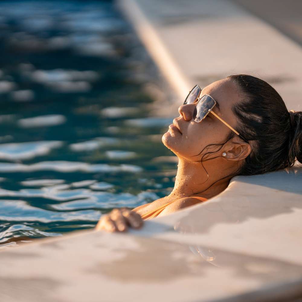 Woman relaxing in the pool at Proximity Carolina Beach in Carolina Beach, North Carolina
