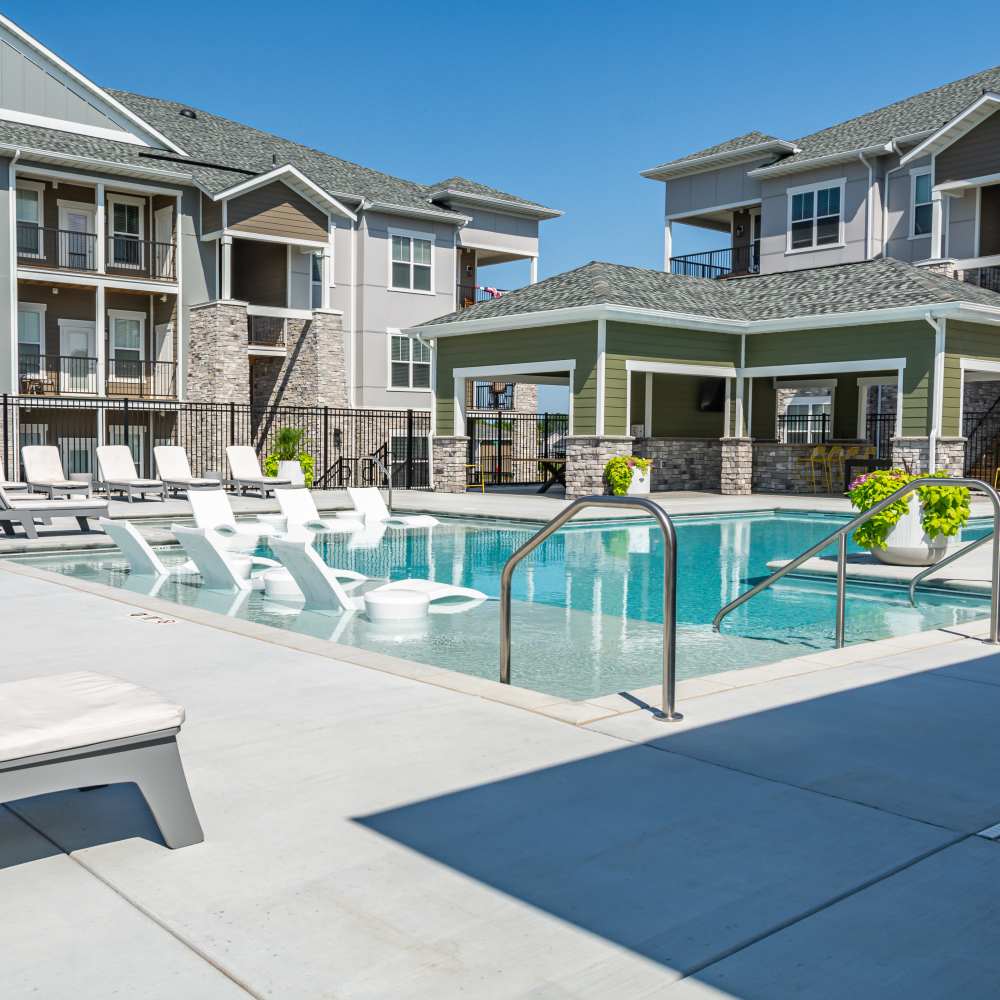 Swimming pool with multiple lounge chairs at Citrine at Lake St. Louis in Lake Saint Louis, Missouri
