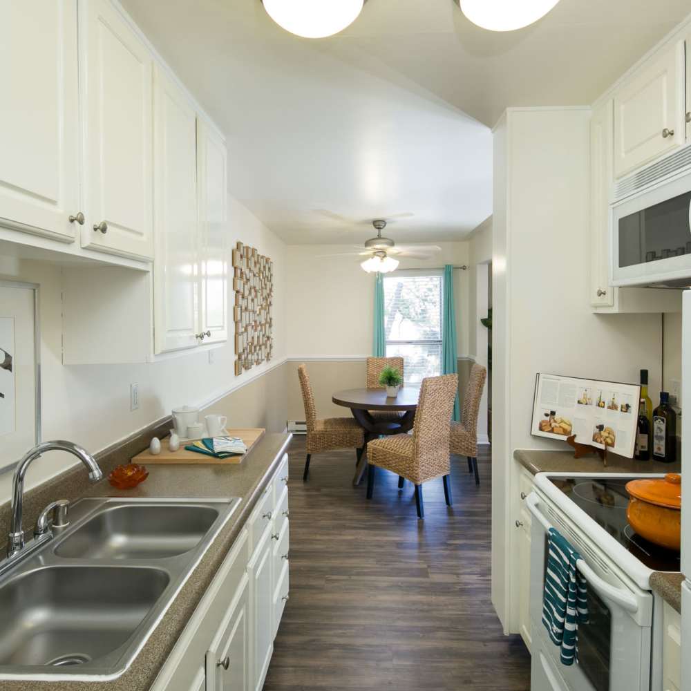 Modern kitchen with stainless-steel appliances at Bayside Apartments in Pinole, California
