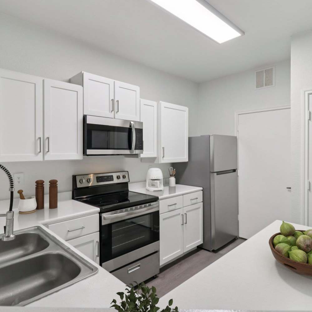 Kitchen with white color cabinets at Harlan at Med Center in San Antonio, Texas 