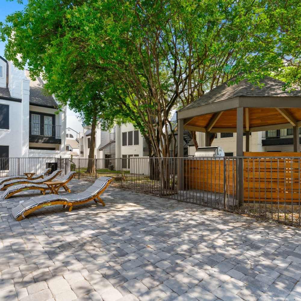 Lounge chairs beside the swimming pool at Rayside Residences in Garland,Texas