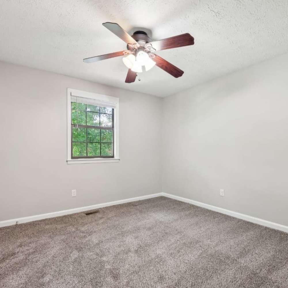 Empty bedroom with large windows and ceiling fan at Davis Park in Smyrna, Tennessee
