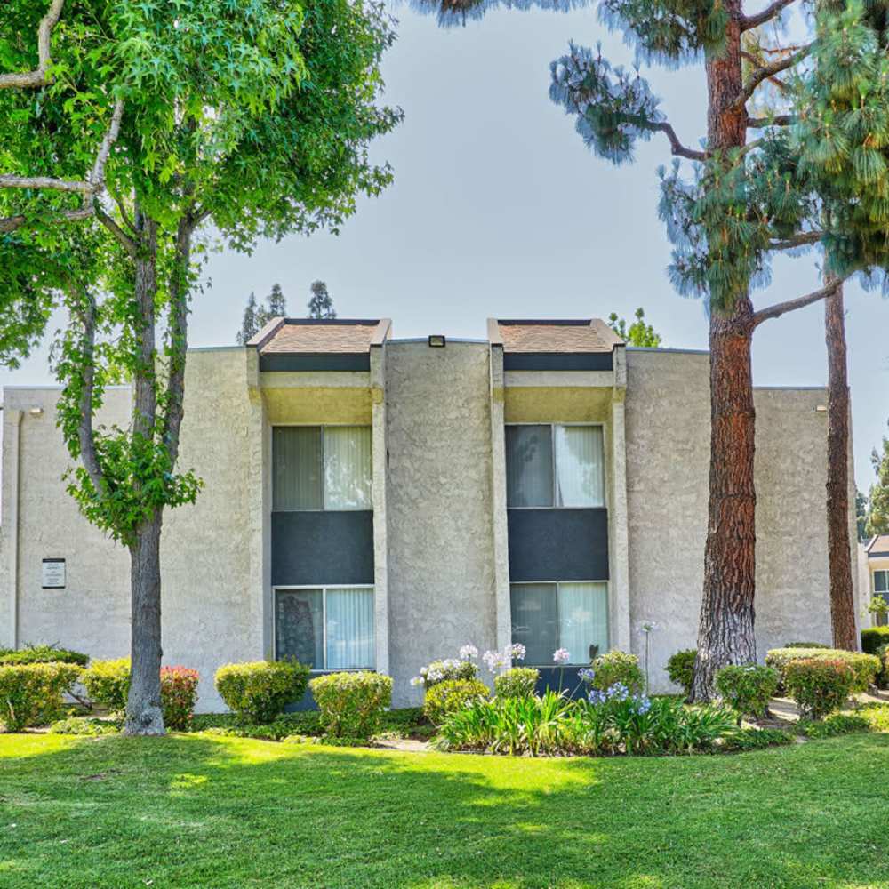 Community building exterior view with lawn  at Pendleton Arms in Sun Valley, California 