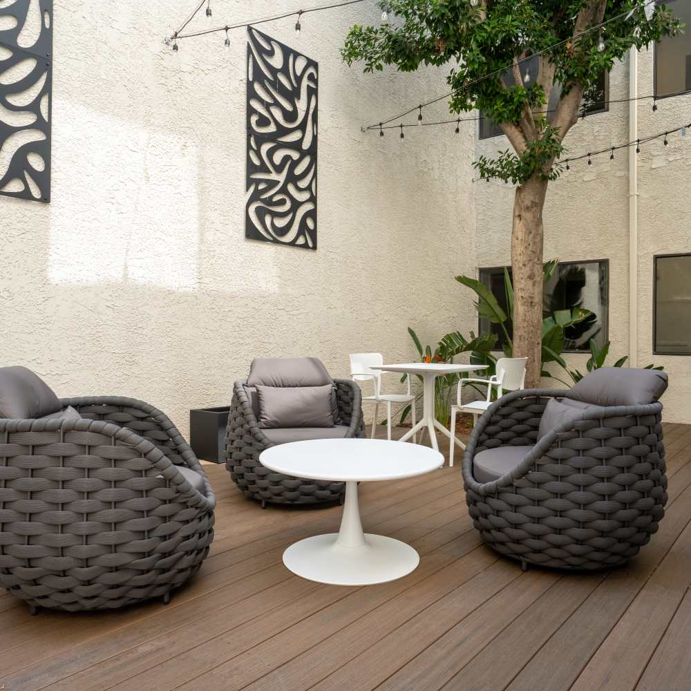 Modern courtyard with two woven lounge chairs at Canyon Village in North Hollywood, California