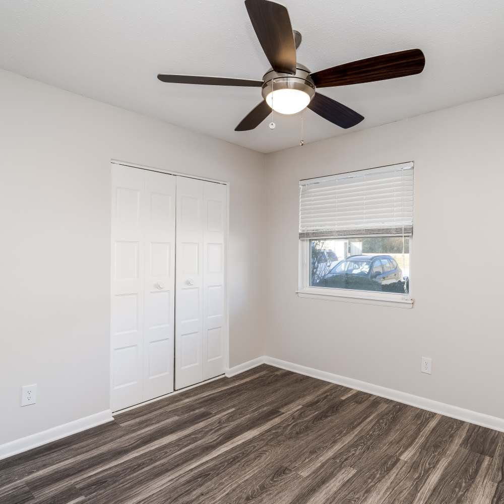 Well-lit bed bedroom with large windows at The Links in Chattanooga, Tennessee