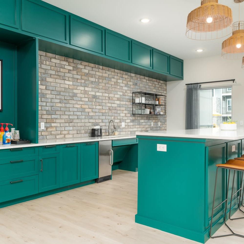 Clubhouse kitchen with green colored cabinets at Citrine at Lake St. Louis in Lake Saint Louis,Missouri