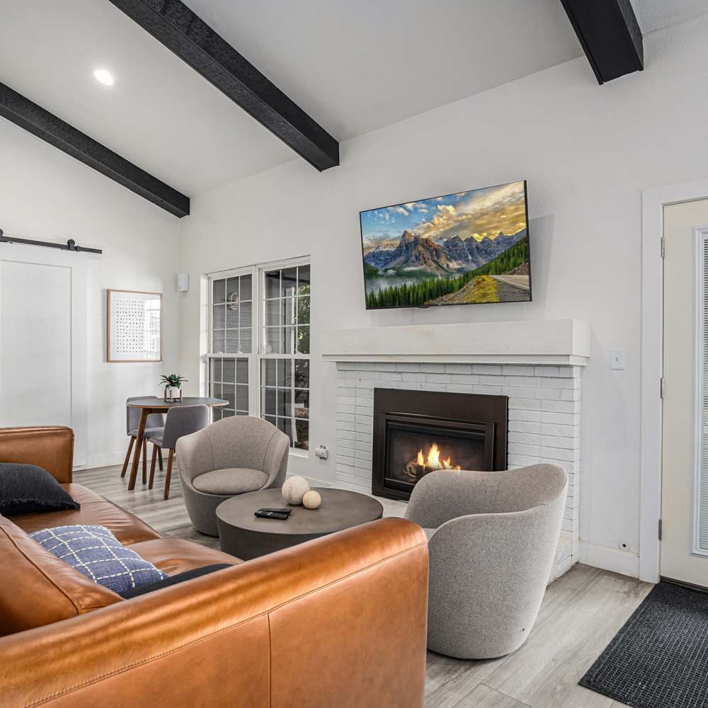 Living room with a fireplace at Oakdale Springs Apartments in Colorado Springs, Colorado