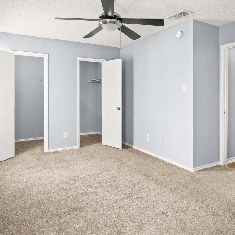 Bedroom with walk-in closet at North Hills Place in Richland Hills, Texas
