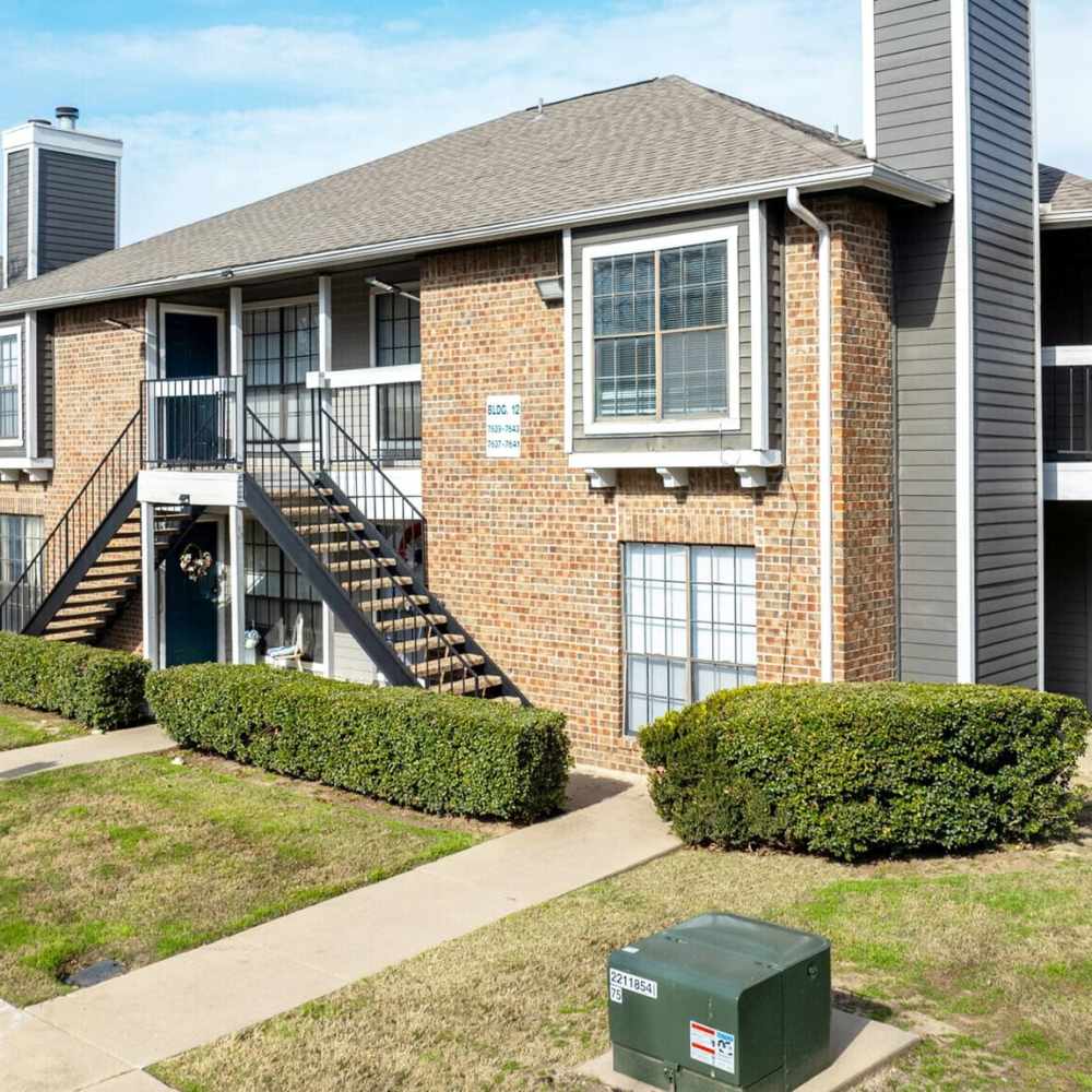 Exterior of the community with lots of lawn at North Hills Place in Richland Hills, Texas