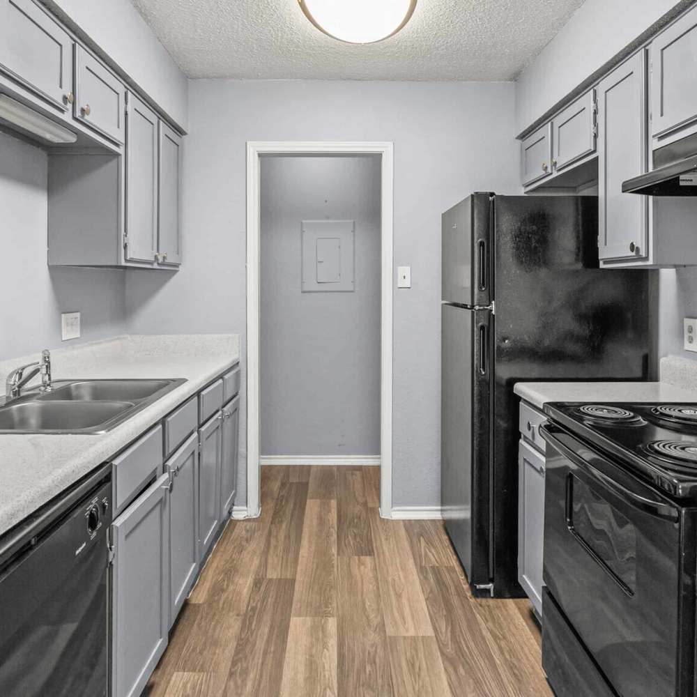 Kitchen with black appliances at North Hills Place in Richland Hills, Texas
