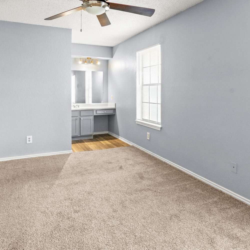 Bedroom with ceiling fan at North Hills Place in Richland Hills, Texas