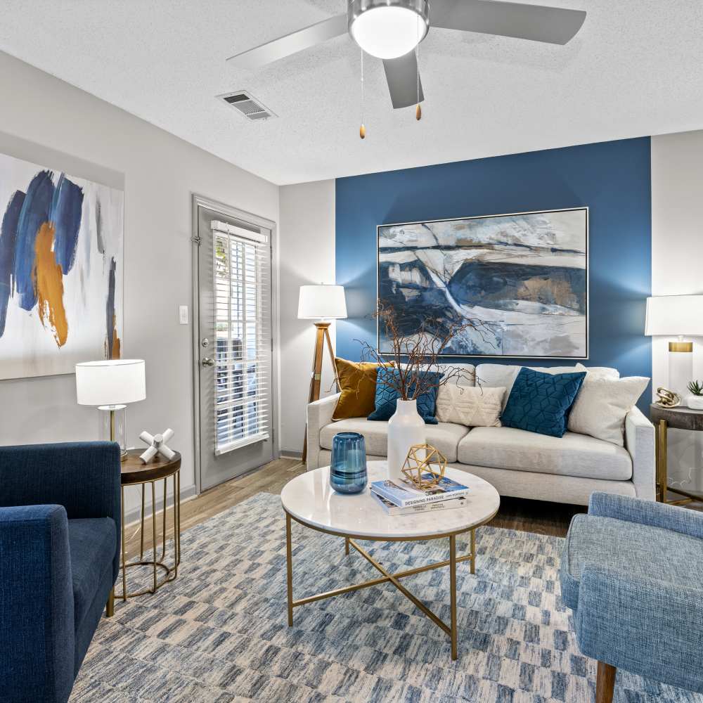 Cozy living room with a ceiling fan at Ascent Apartment Homes in Asheville, North Carolina