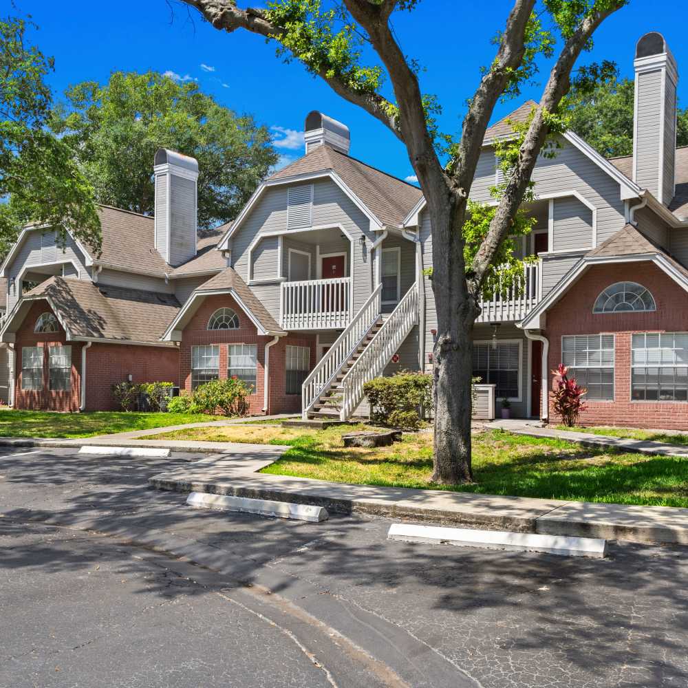 Residential building exterior with brick accents, balconies, and landscaped surroundings at Twin Lakes, Palm Harbor, Florida