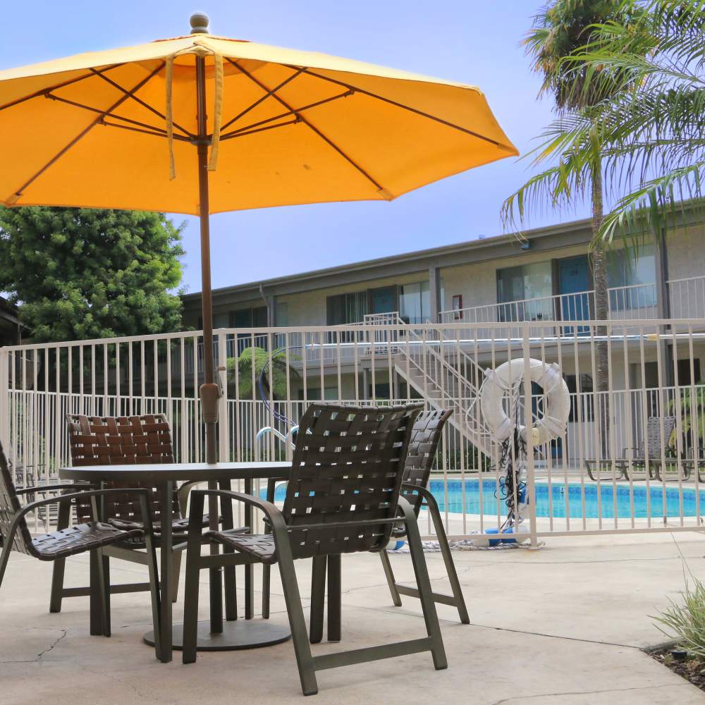Table and chairs by the poolside at Sandpointe in Huntington Beach, California