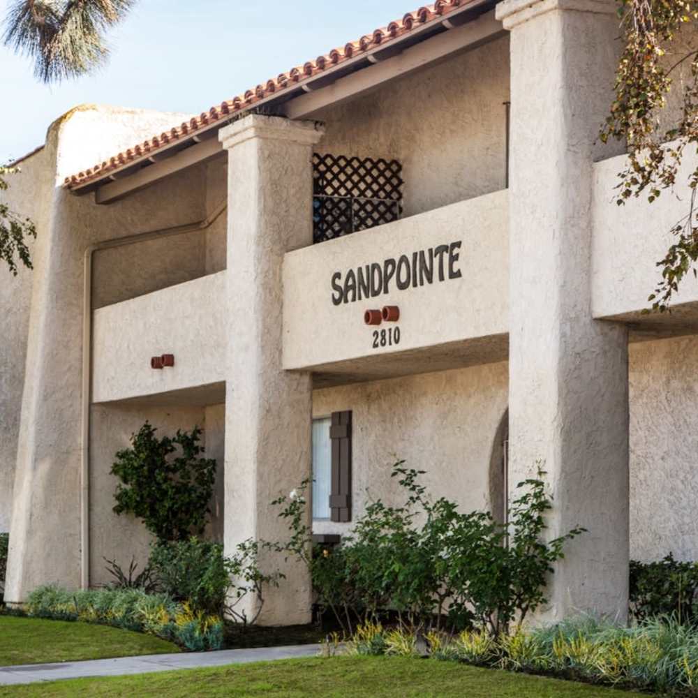 Building exterior with name at Sandpointe in Huntington Beach, California