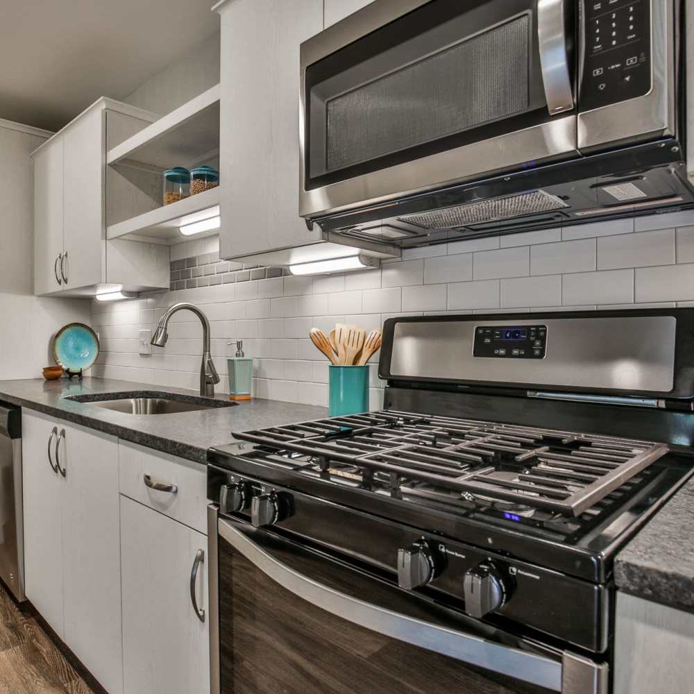 Sleek modern kitchen with stainless steel appliances and stylish decor at Avonlea Riverside in Atlanta, Georgia