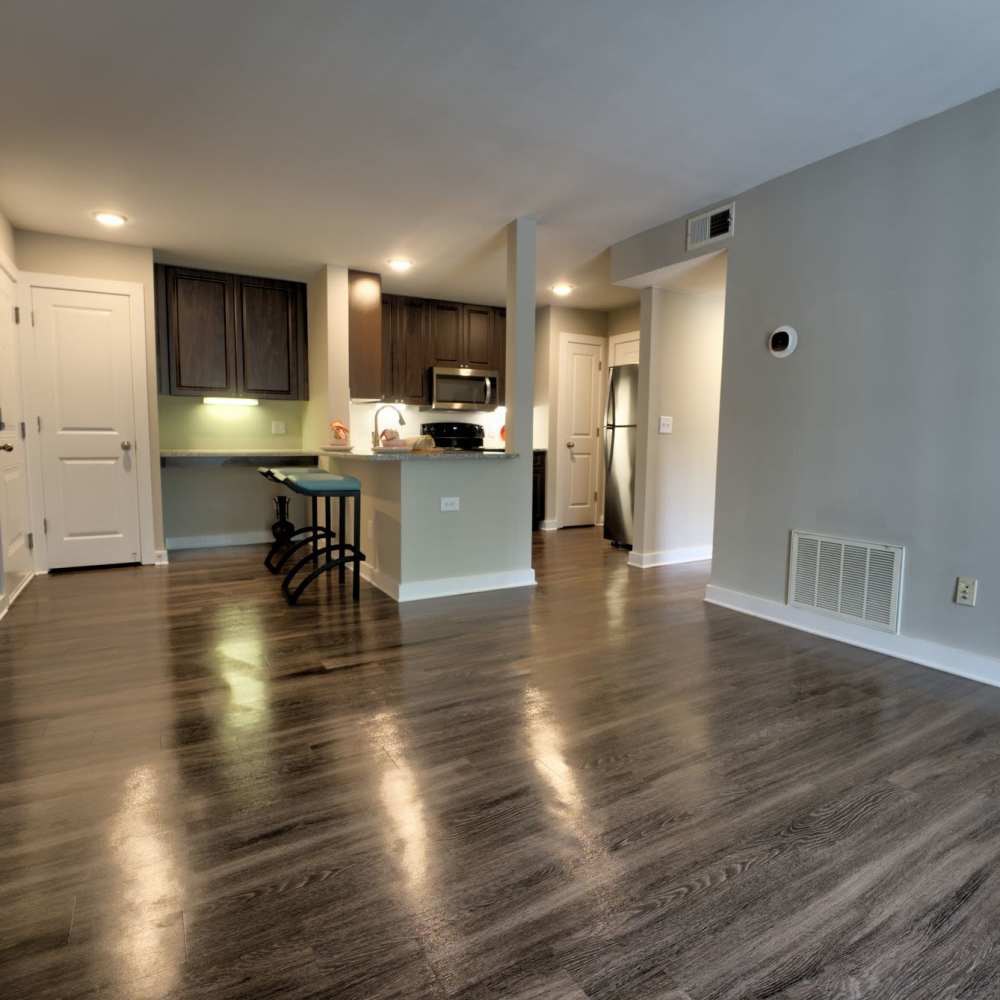 Modern kitchen with sleek cabinets and polished hardwood floors at Avonlea Riverside in Atlanta, Georgia