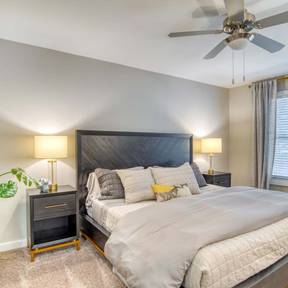 Cozy bedroom with modern decor and natural light at Avonlea Riverside in Atlanta, Georgia