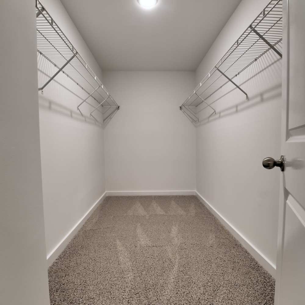 Spacious walk-in closet with wire shelving and polished floor at Avonlea Riverside in Atlanta, Georgia