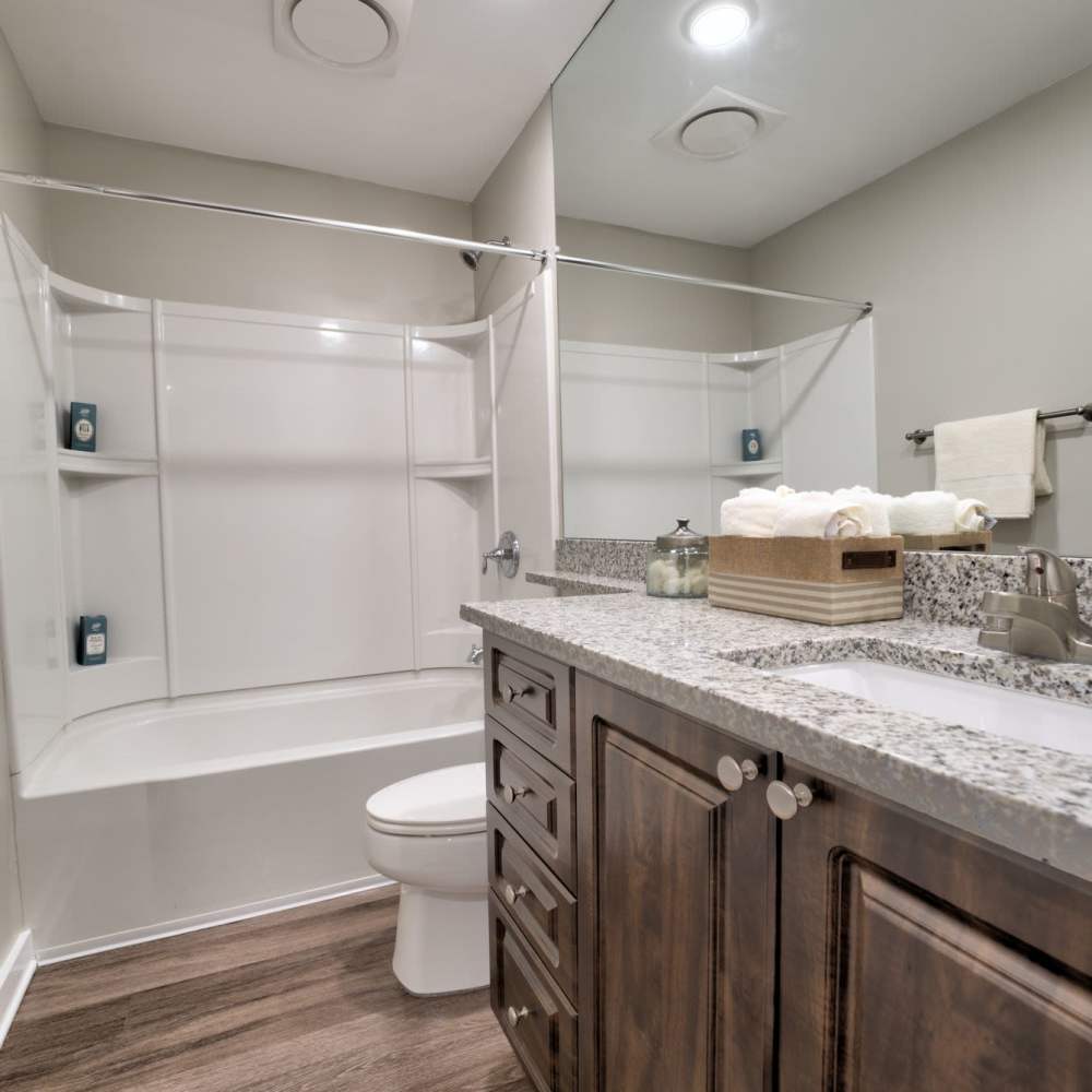 Modern bathroom with sleek granite countertops and stylish storage at Avonlea Riverside in Atlanta, Georgia