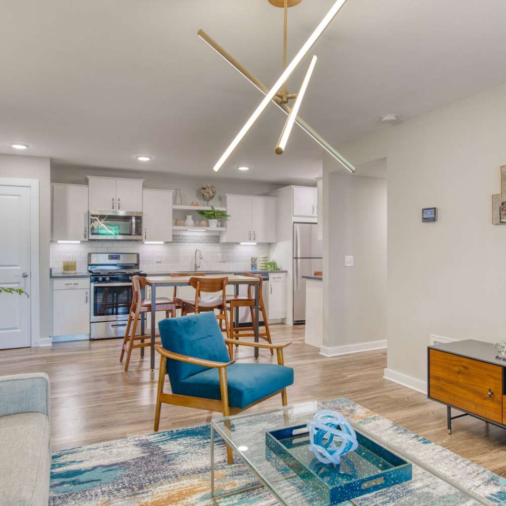 Modern kitchen with stylish chairs and cozy living area at Avonlea Riverside in Atlanta, Georgia