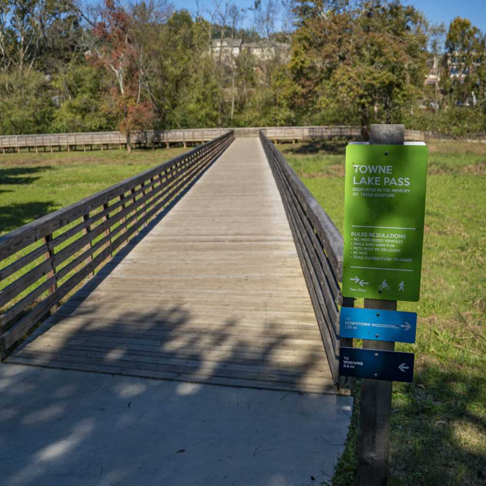 Bridge with greenery around at Avonlea Towne Lake in Woodstock, Georgia