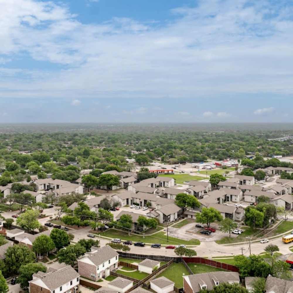 Aerial view of green suburban neighborhood with modern homes at Woodlands of Plano in Plano, Texas