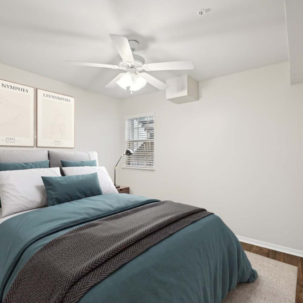 Cozy bedroom with modern decor and natural light at Woodlands of Plano in Plano, Texas