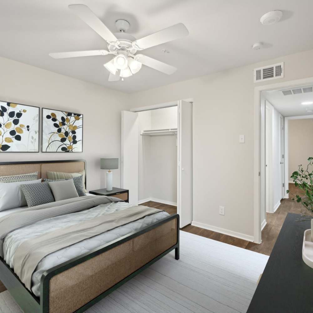 Spacious bedroom with stylish decor and ample closet space at Woodlands of Plano in Plano, Texas