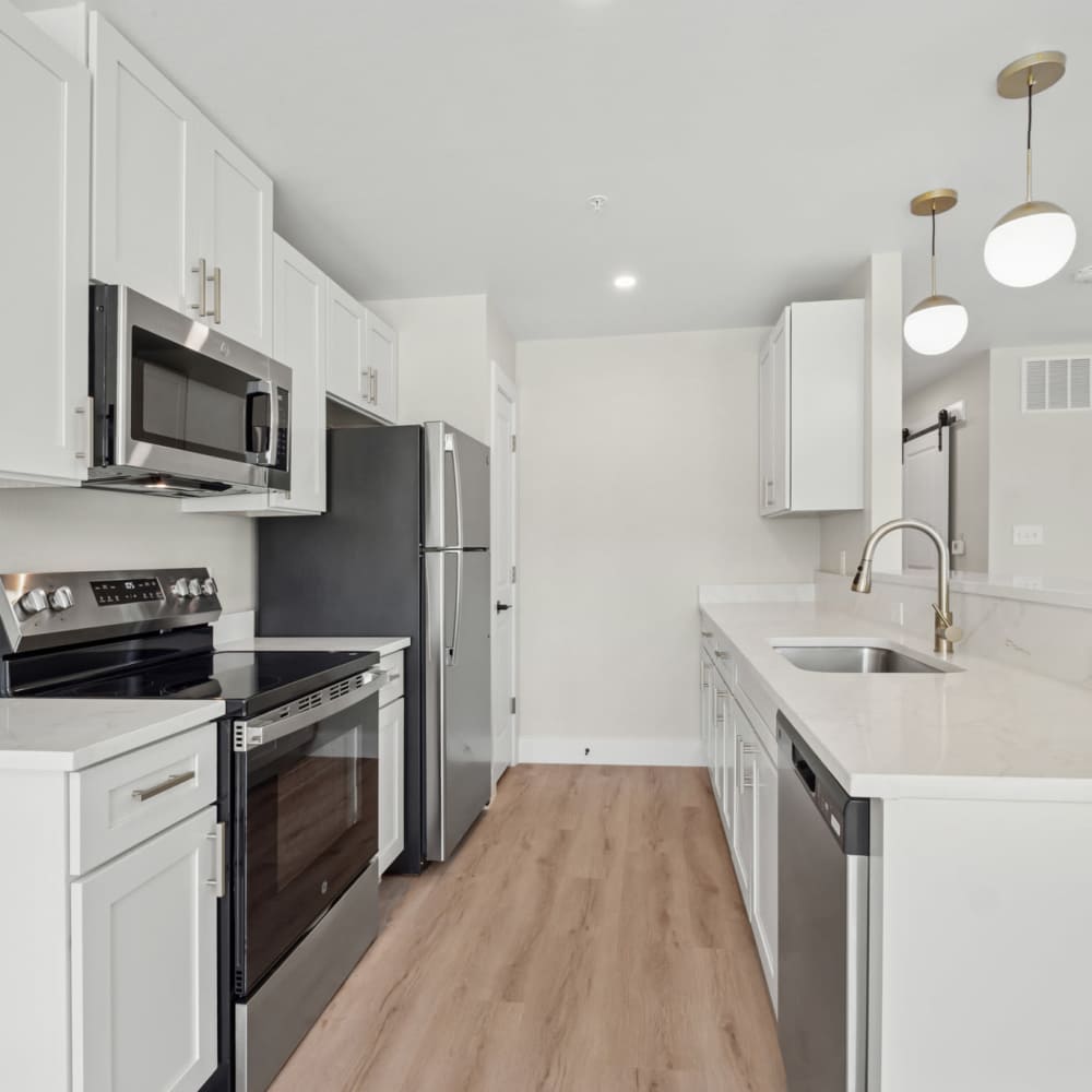 Modern kitchen with wooden cabinets and stainless-steel appliances at Lake Meadows in Garland, Texas