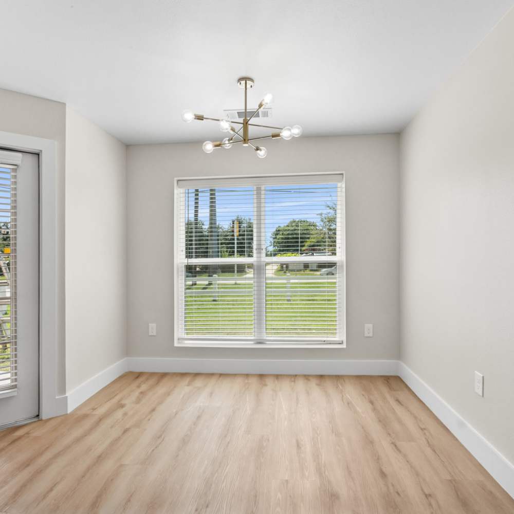 Living room with a large window at Lake Meadows in Garland, Texas