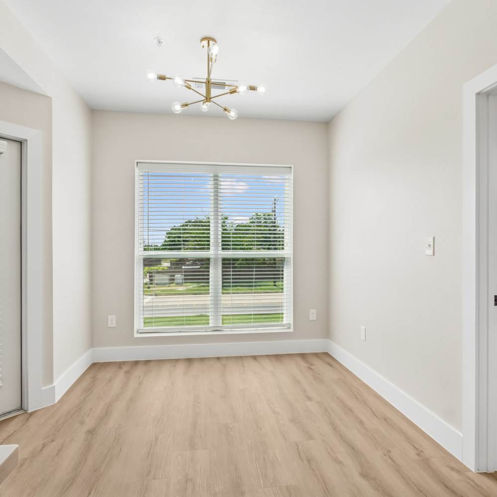 Bright living room with a large window at Lake Meadows in Garland, Texas