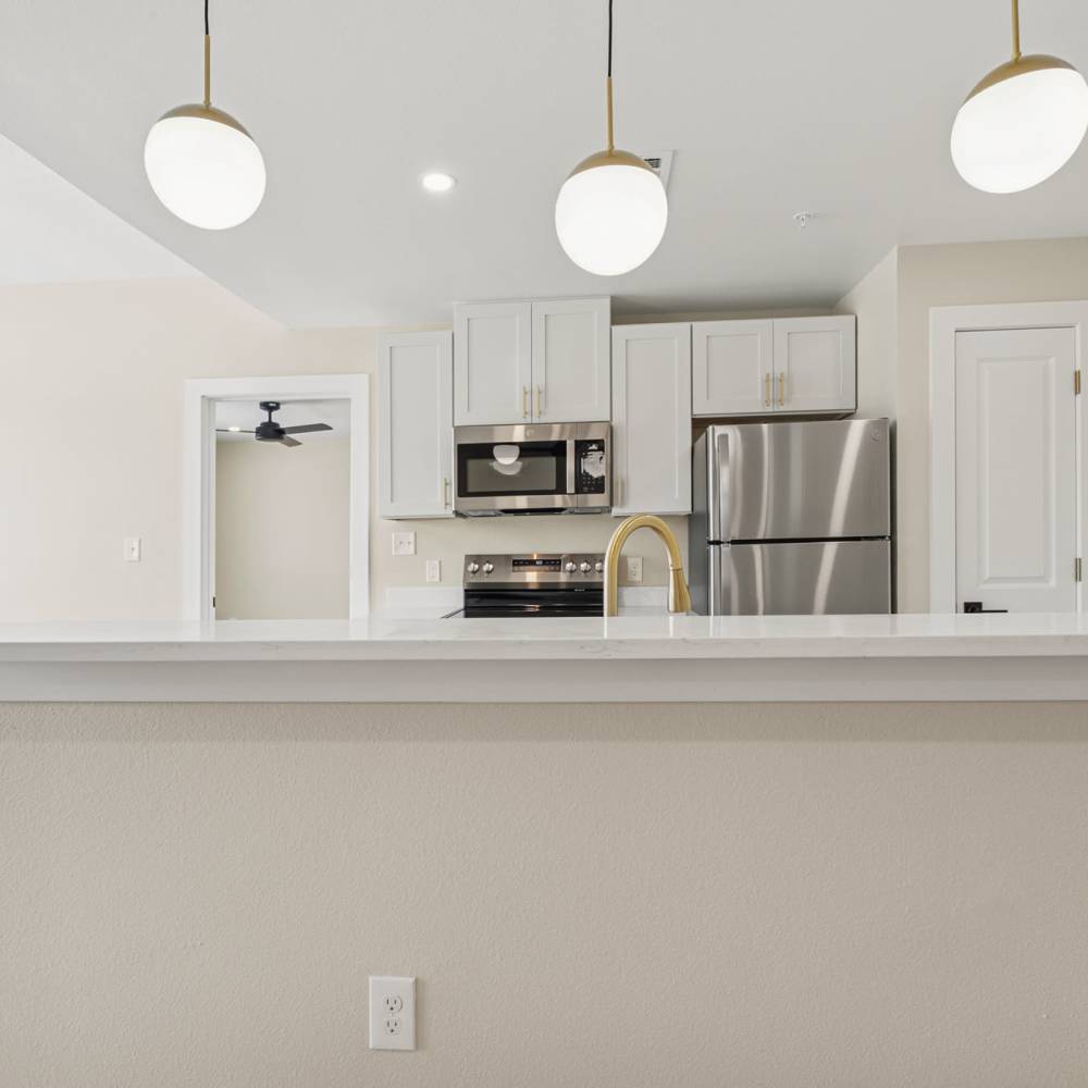 Kitchen with stainless-steel appliances at Lake Meadows in Garland, Texas
