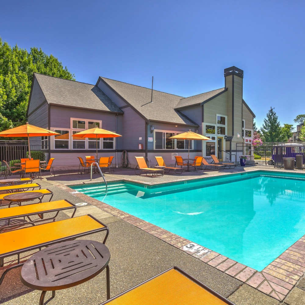 Outdoor pool with view of clubhouse at Plum Tree Park in Renton, Washington