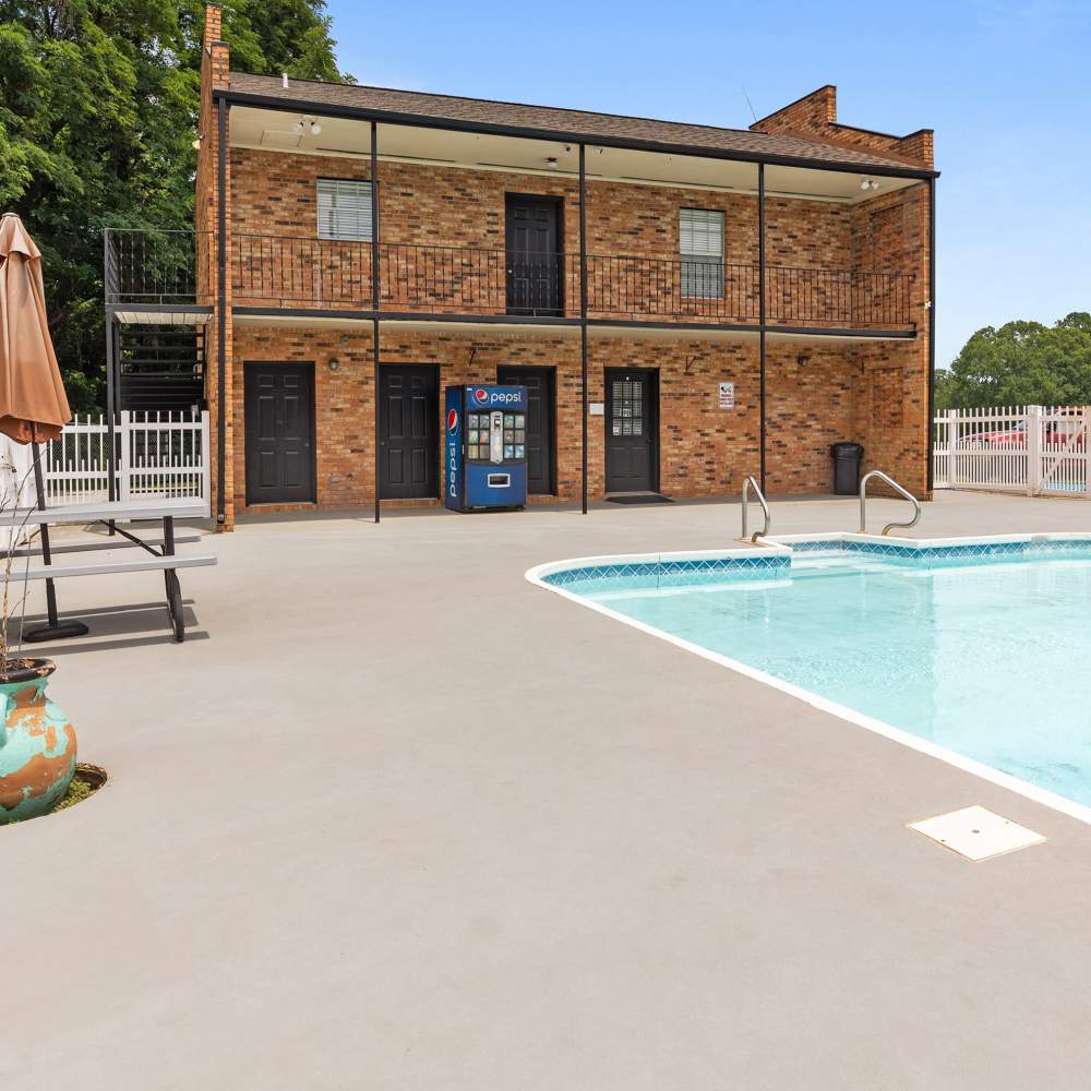 Charming courtyard with a sparkling water pool and cozy brick façade at Pecan Ridge in Vicksburg, Mississippi.