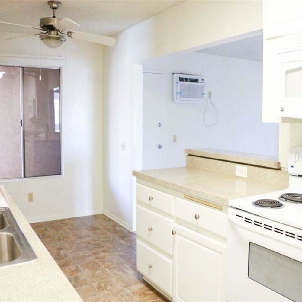 Kitchen with white appliances at Casa Madrid in Cypress, California