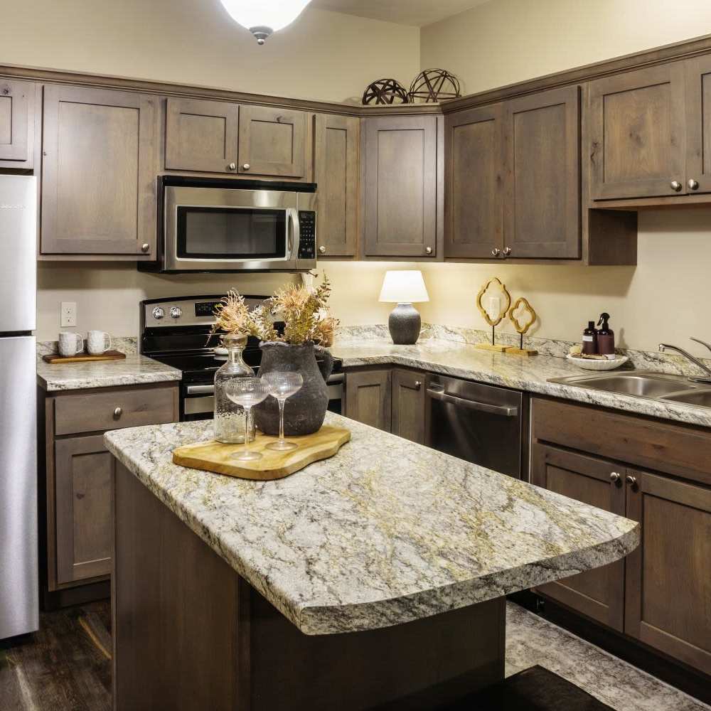 Kitchen with wooden cabinets at InterUrban Apartments in Billings, Montana