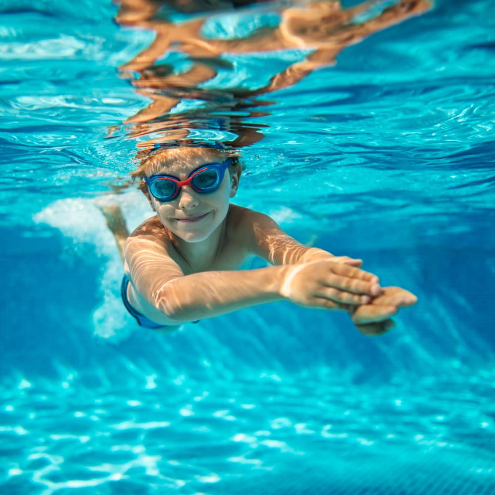 Kid swimming in a pool at Lake Lucerne Towers in Orlando, Florida
