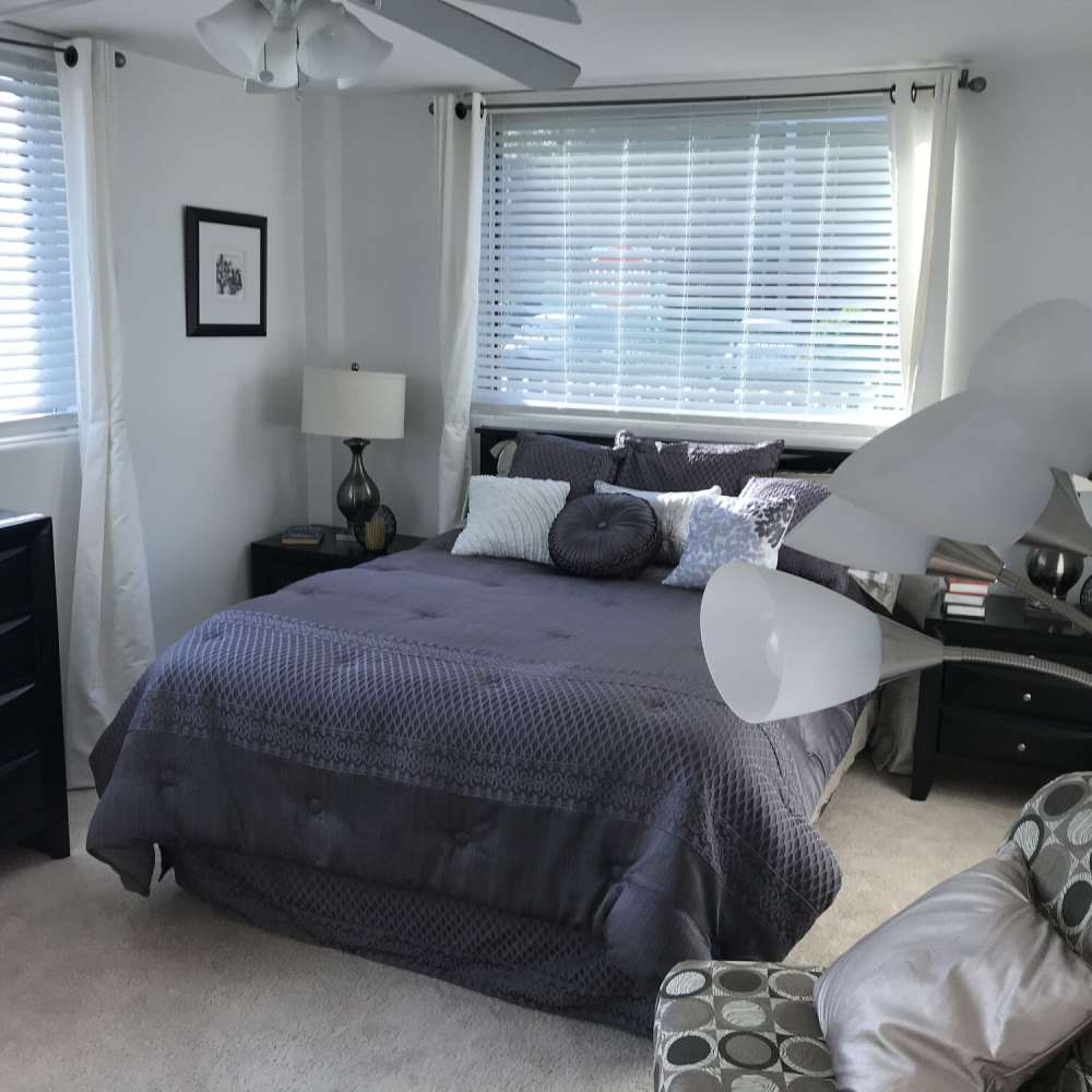 Bedroom with large bed at Lake Lucerne Towers in Orlando,Florida