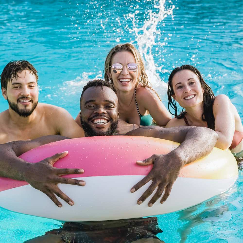 Resident with friends in pool at The Depot at North Salem in Apex, North Carolina