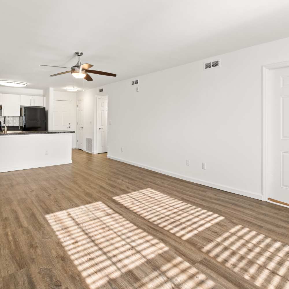 Spacious living area with wood style flooring at Equinox at Midtown in Chattanooga, Tennessee