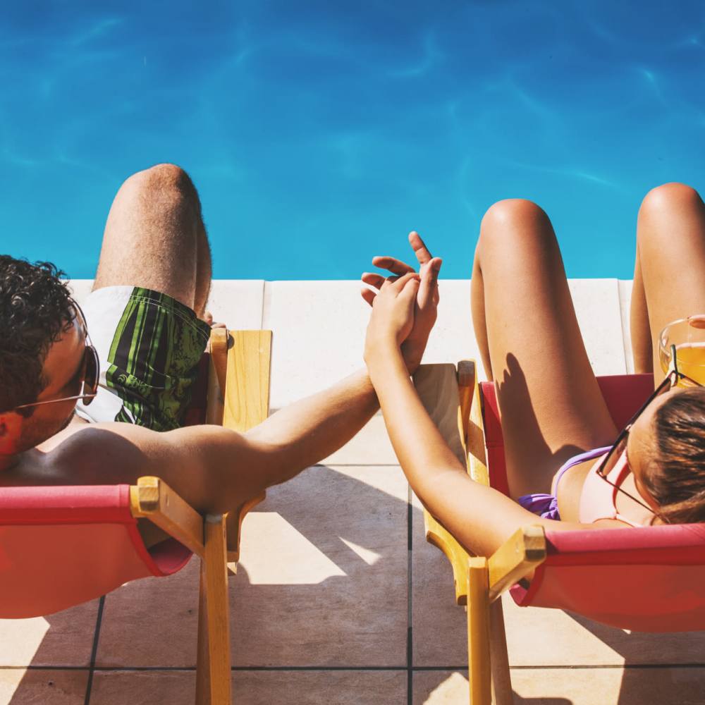 Resident couple near pool side at The George Apartment Homes in Savannah, Georgia 