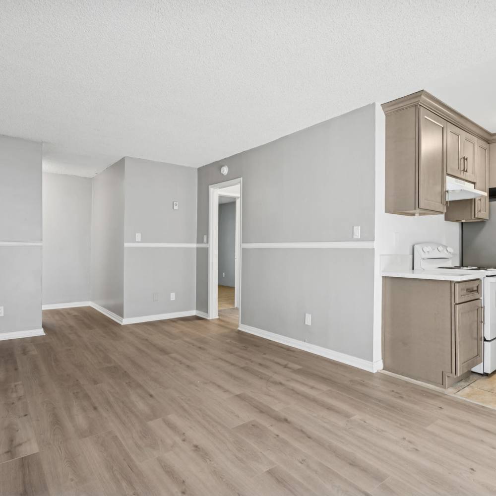 Unfurnished living room with view to kitchen at Newland Garden Apartments in Garden Grove, California